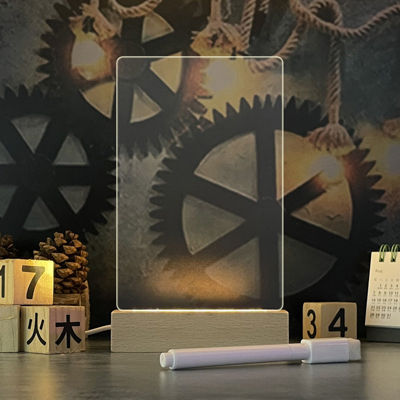 The note board in its tall vertical shape, edge-lit warm-white in a wooden stand with the marker pen in front