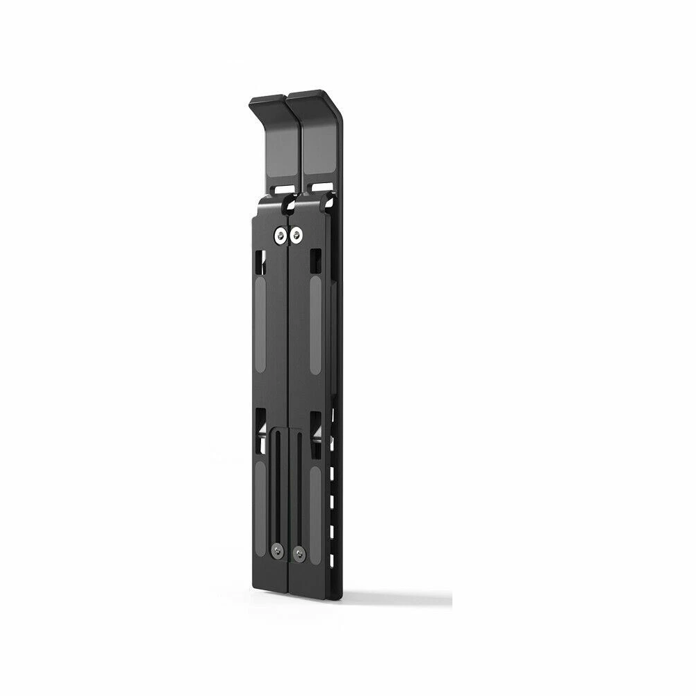 Black foldable laptop stand, folded flat and closed, standing upright at an angle on a plain white background, with silver screws visible on its face.