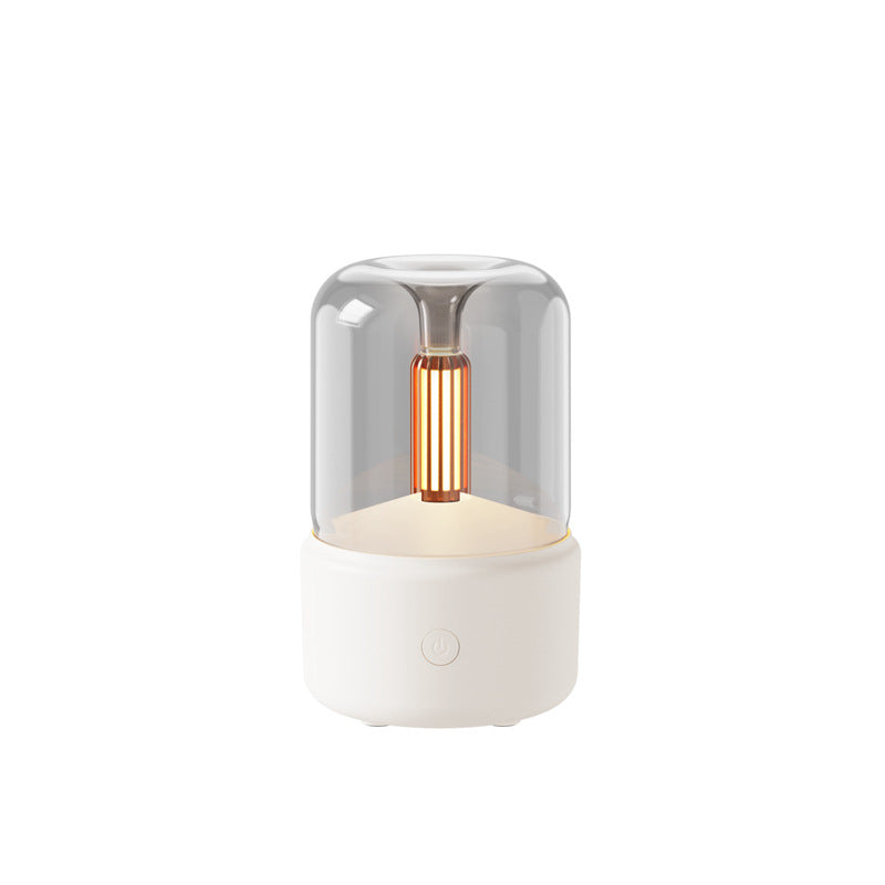 Candlelight Humidifier flame-effect aroma diffuser with a warm amber glow inside its glass dome, on a cream base