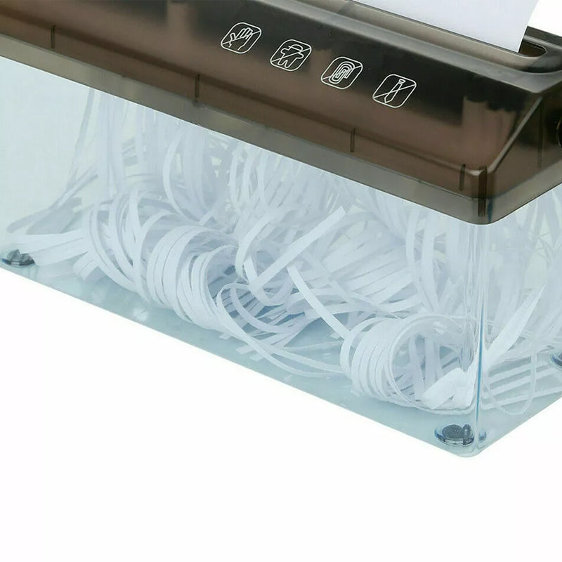 Close-up of the shredder's clear bin, filled with narrow strip-cut paper.