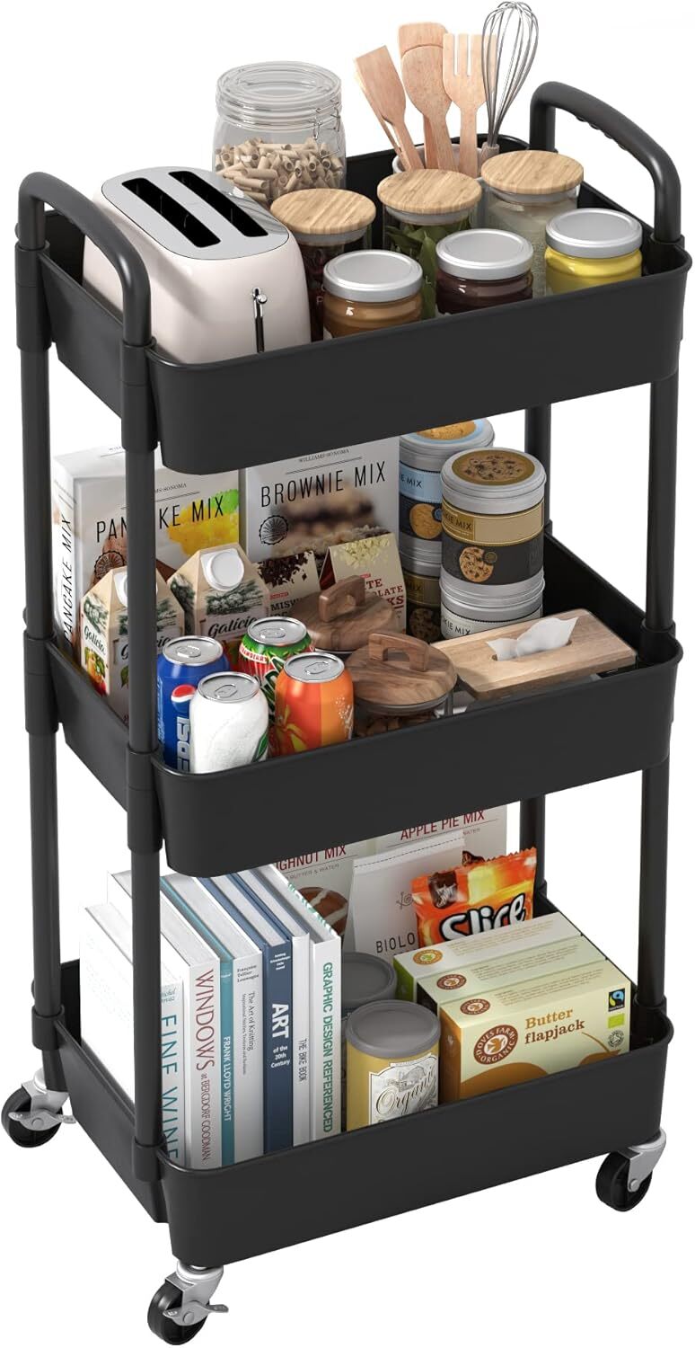 Black three-tier plastic rolling storage trolley on four wheels, filled with kitchen jars and packets.