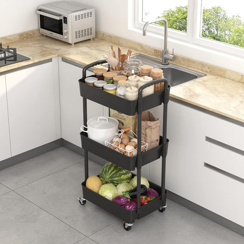 The black storage trolley standing beside a kitchen sink with vegetables on its lowest tier.
