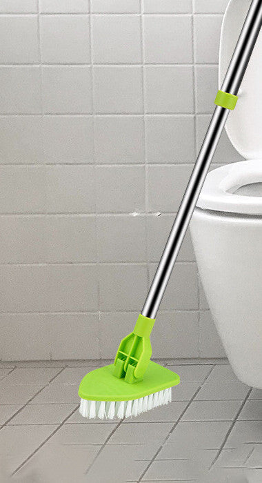 Stiff bristle brush head on a tiled bathroom floor beside a toilet, with the pole extended